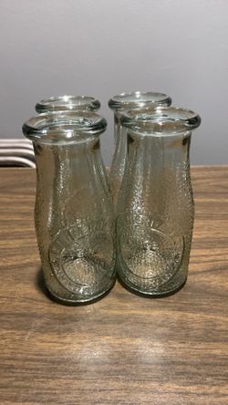 Four milk bottle glasses
