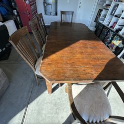  rustic oak dining table set with a matching bench and chairs