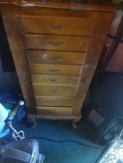 light oak-style Queen Anne jewelry armoire featuring multiple drawers and side doors for storage