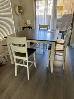 Counter height rectangular dining table. 4 chairs and bench