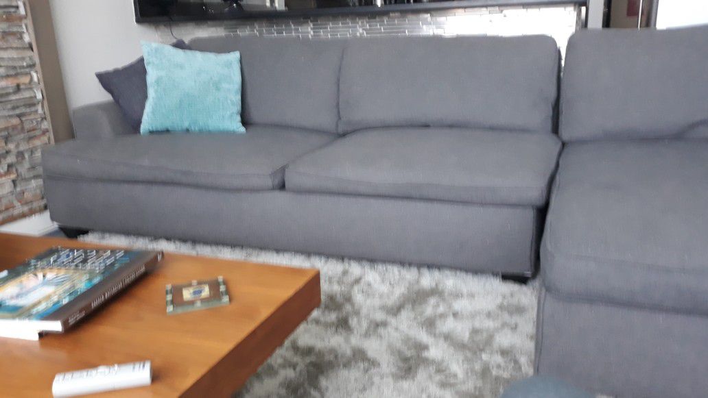 Sectional sofa. Comfortable modern grey. Excellent condition clean non smoker.