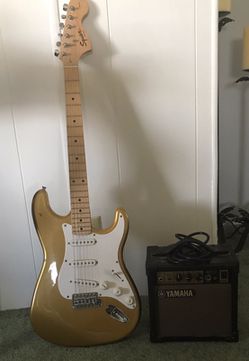 Gold electric guitar with amp