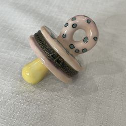 Vintage pink ceramic pacifier trinket box with blue polka dots.