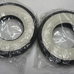 The image shows two new bicycle tires with white sidewalls