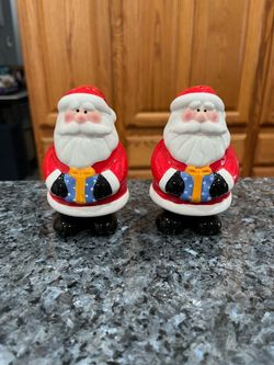 Ceramic Santa With Present  Pair of Salt and Pepper Shakers.  Size Santa is 4 inches tall.  Preowned never used.  Has been on display in a cabinet wit
