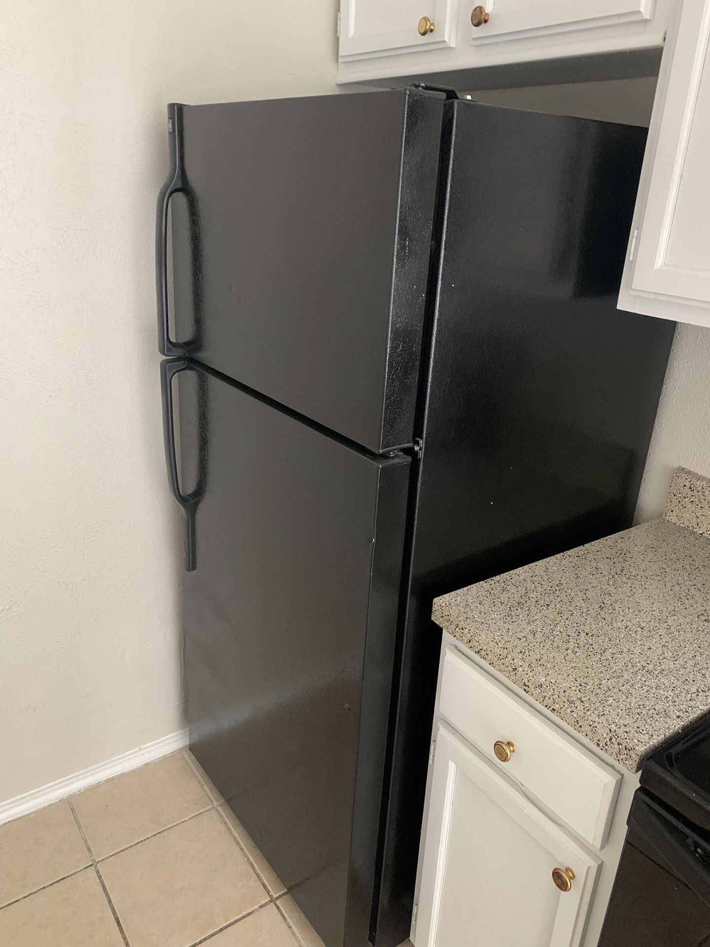 Black GE Refrigerator. Top Freezer. Works. Very clean. Very cold.