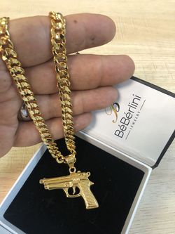 24” long (available in different lengths) gold Cuban necklace and stainless steel Handgun pendant top quality guarantee 💯💯💯matching bracelet is ava