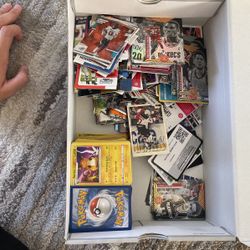 a bunch of pokémon, nba, and nfl cards