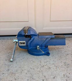Central Forge 5-inch bench vise featuring a swivel base and built-in anvil.