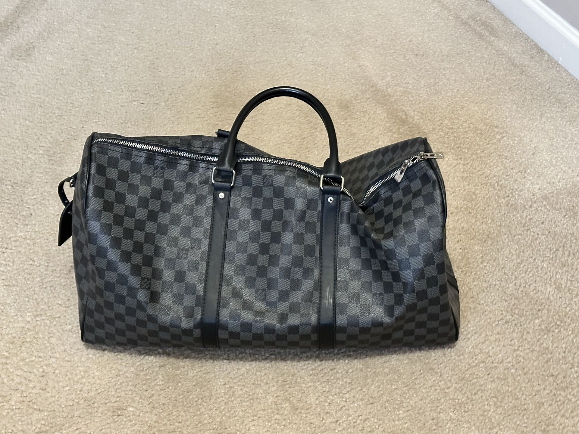 Authentic Louis Vuitton Keepall Bandoulière 55 in the sleek Damier Graphite canvas