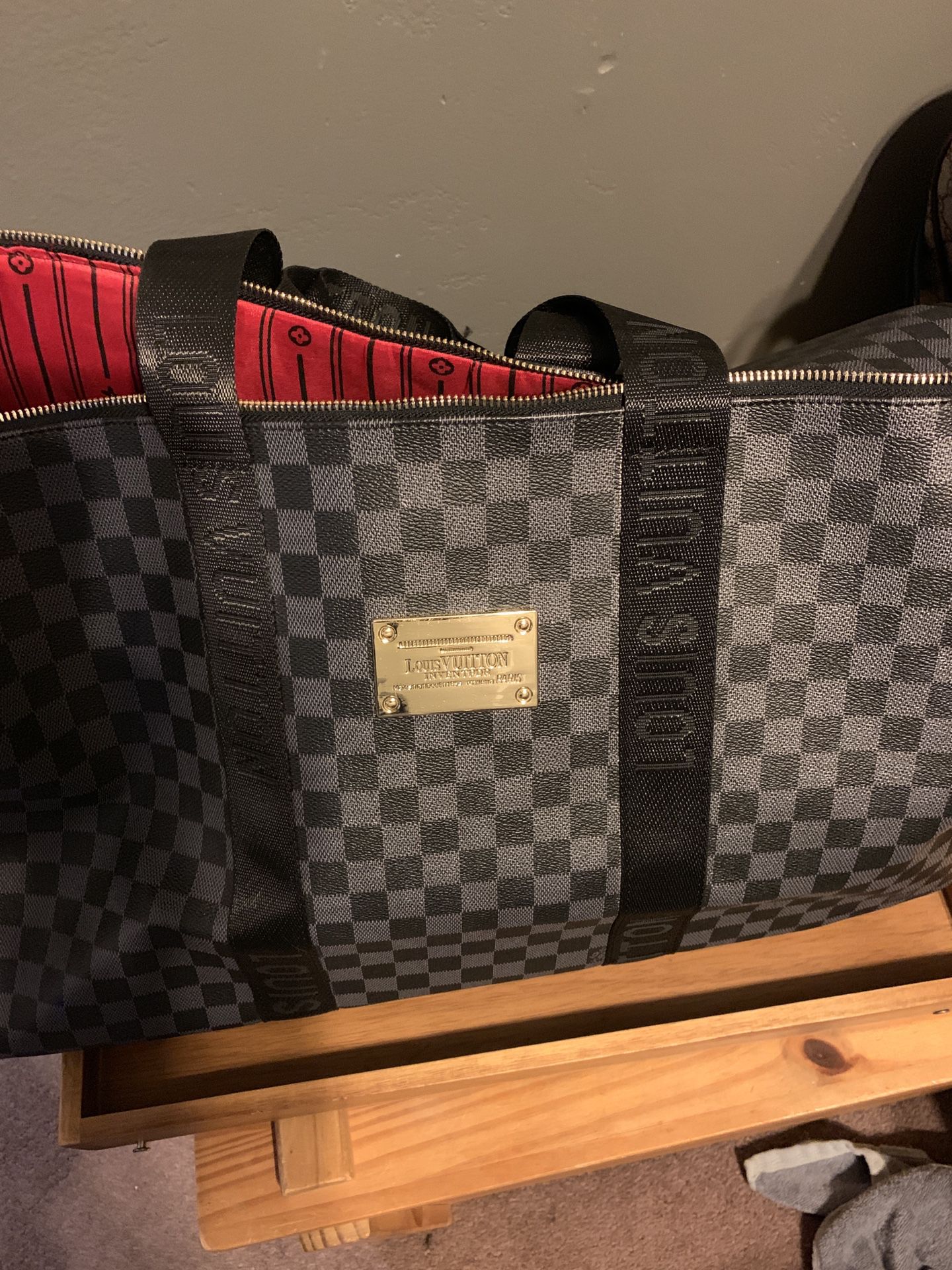 Black and grey Louis Vuitton duffle bag