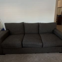 dark grey living spaces couch 