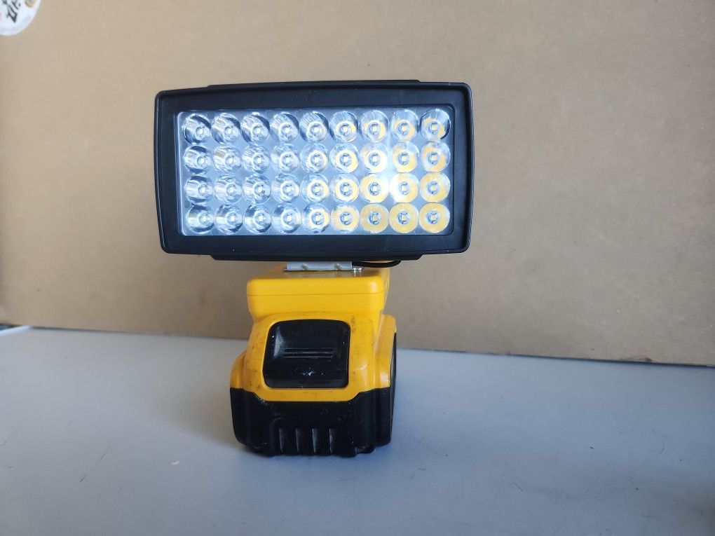 Work lamp.61/4"L 31/4" it has USB charger. Pretty bright.