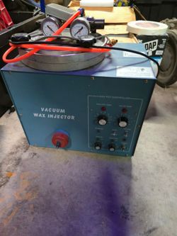 A vacuum wax injector