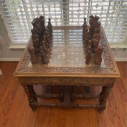 Contemporary hand carved chess table with 2 benches and a complete set of incredibly detailed hand carved chess pieces.