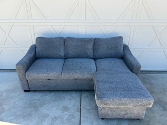 Dark Grey Sectional with Rollout Ottoman and Storage Chaise