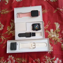 A Apple Watch And Two Smart Watches 