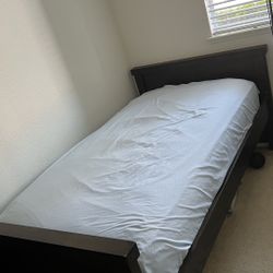 A good-quality solid wood twin bed with the mattress.