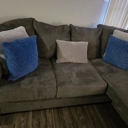 Grey Couch  Two  Blue Pillows  Two Grey Pillows 