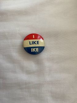 This is a vintage 1956 "I Like Ike" campaign pin supporting Dwight D. Eisenhower.Historical Context: The "I Like Ike" slogan was a iconic part of Eise