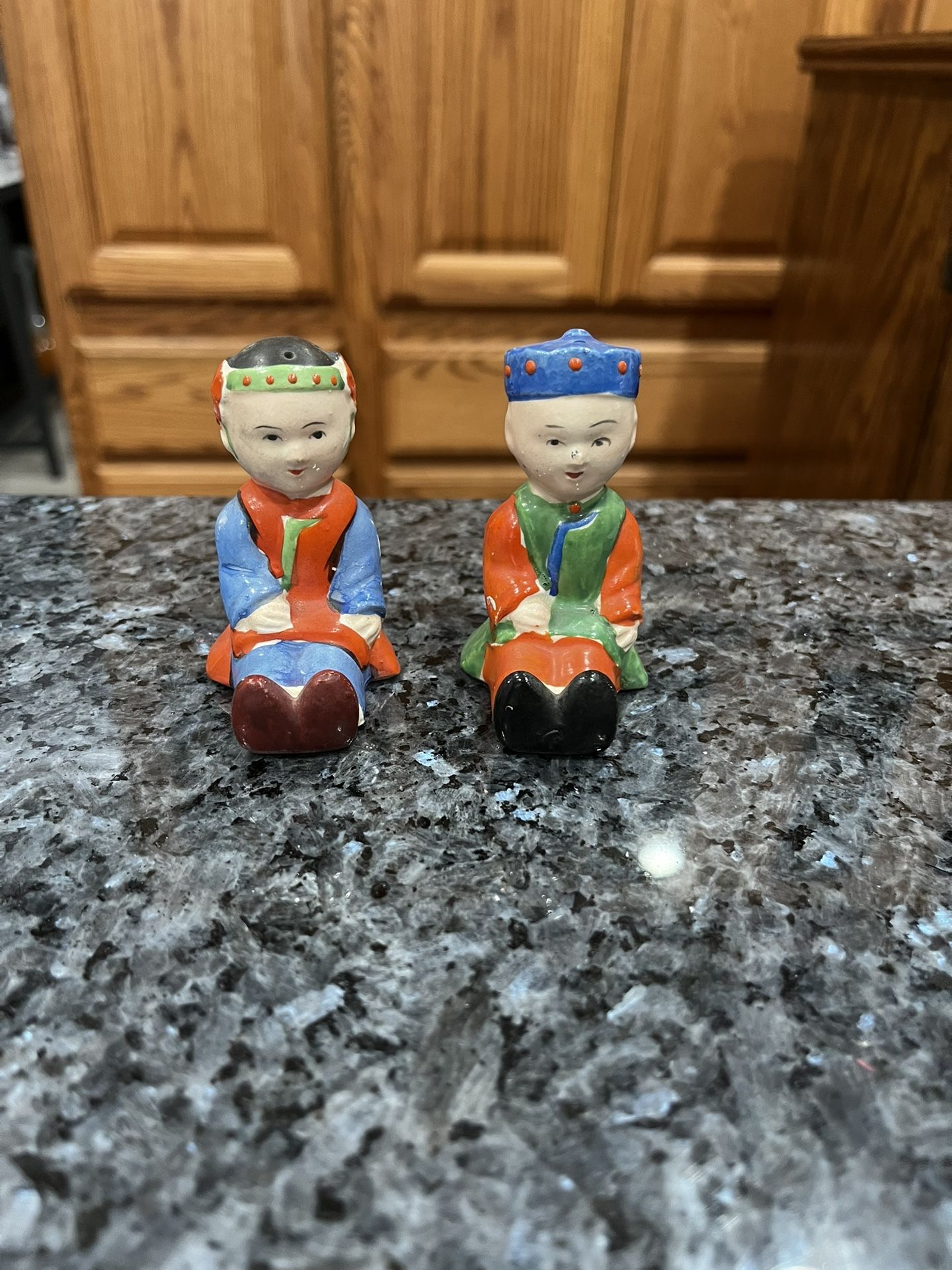 Vintage Porcelain Chinese Man and Woman Boy and Girl Salt and Pepper Shakers. Preowned some minor paint wear due to age. No stoppers. See pictures.