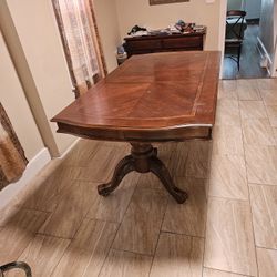 Antique maple drop Solid wood dining room table With no chairs.