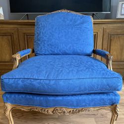French Provincial style chair with blue upholstery.