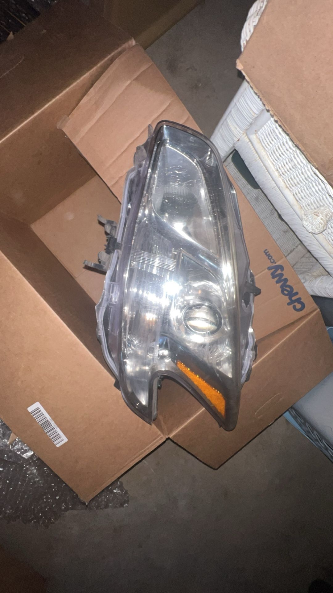 used left-side headlight assembly for a Nissan Maxim