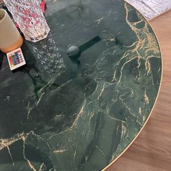 Round coffee table with green faux Marble top