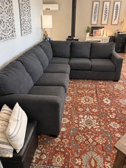 Dark charcoal sectional and rug