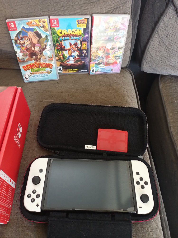 I Have A Nintendo Switch OLED For Sale It's Ben Used One Time Still Brand New It Comes With Three Games And A Case The Docs To Hook It Up To Your TV I