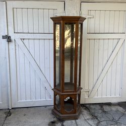 Free mirrored-back curio cabinet.