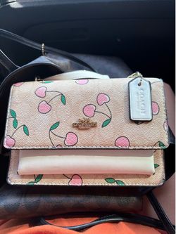 Cherry coach cross body bag