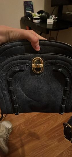 This is an Aimee Kestenberg Midnight Navy leather crossbody saddle bag with black suede whipstitching