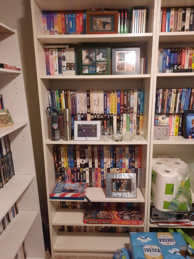 White Shelf With Various VHS Tapes