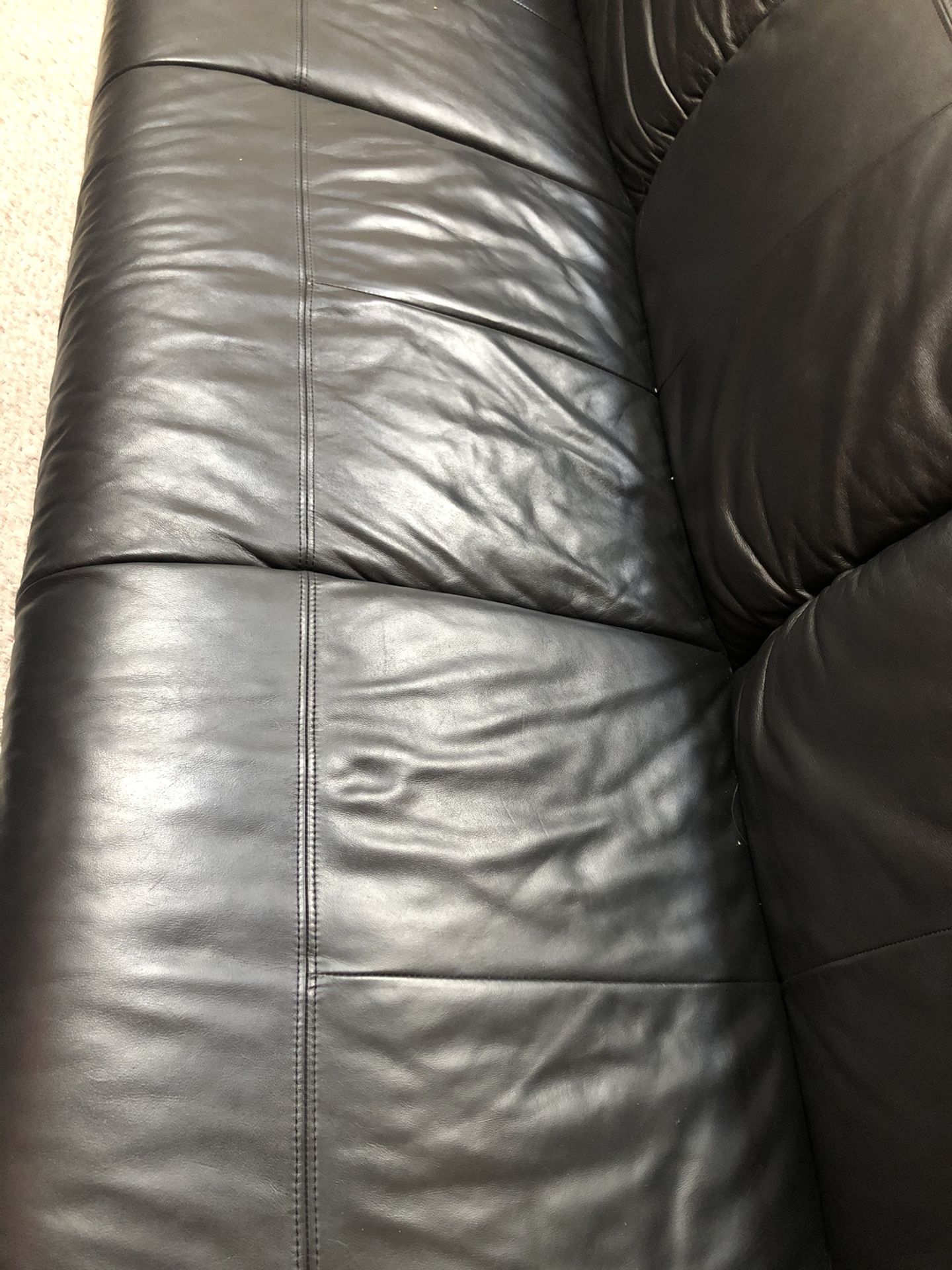 Black leather couch with ottoman