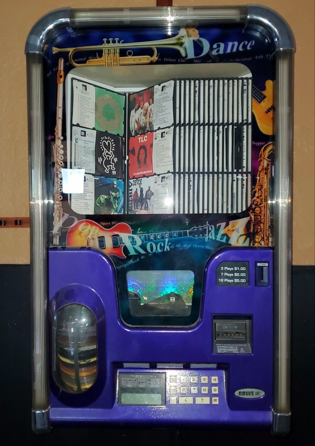 Ami Rowe Wall Mount Jukebox filled with CDs in Comes with wall bracket. Set to Free play or money.