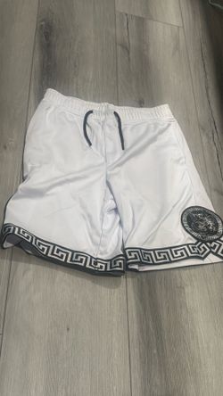 white mesh athletic shorts-black and white Greca (Greek key) border along the leg hems.