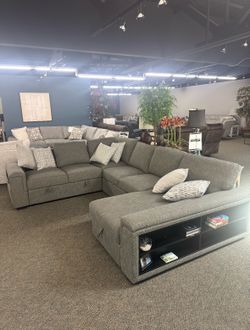 Gray chenille fabric cloud sectional with pullout sleeper and storage