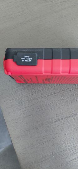 Red and Black Portable Power Bank USB-C also it is a car jump starter with cables