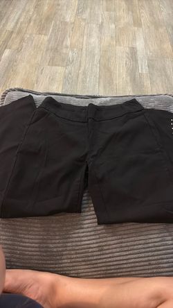 Black work pants with silver decals on the ankles