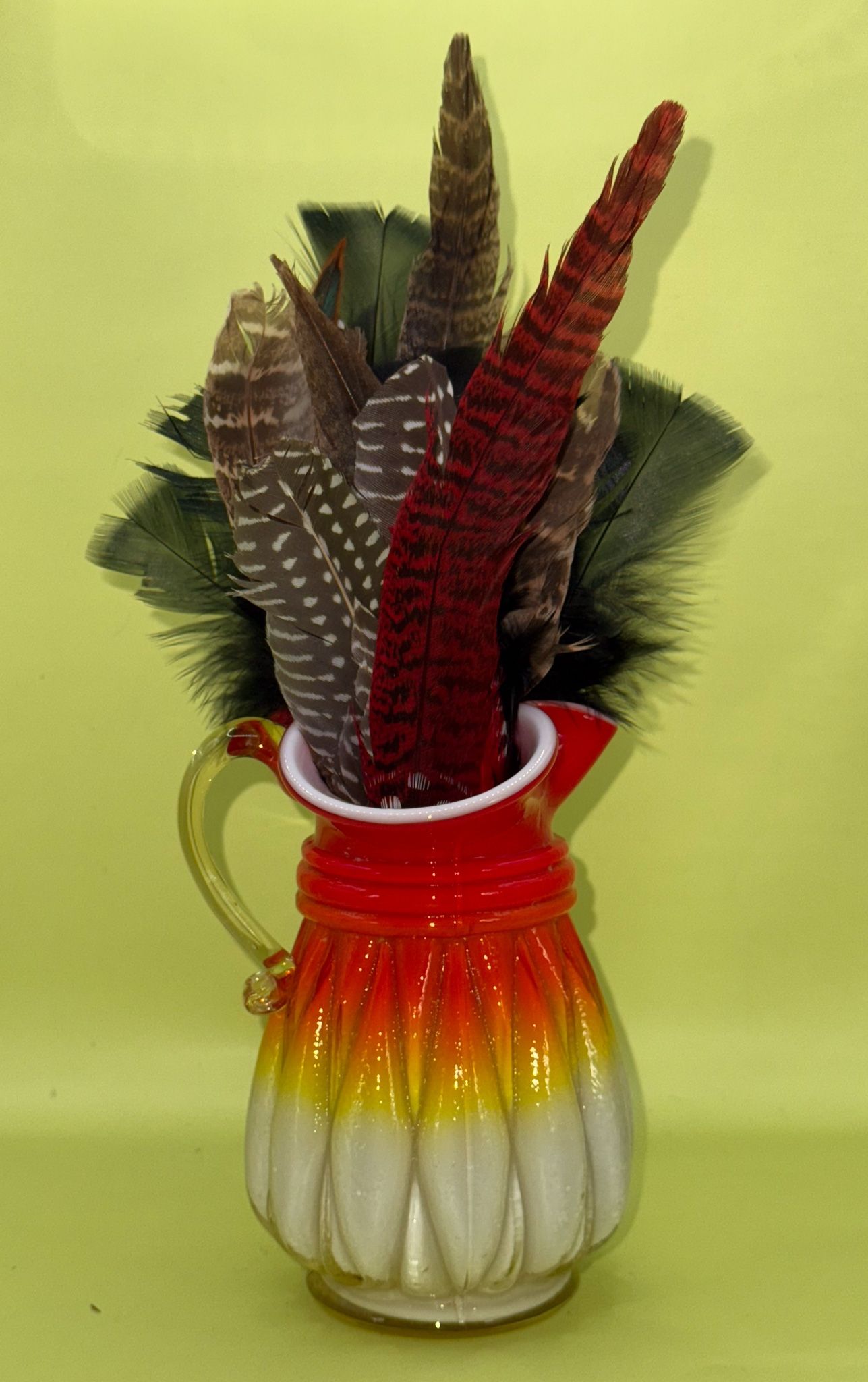 Vintage Kanawha Glass Co. Amberina Cased Milk Glass Pitcher with a ruffled rim.