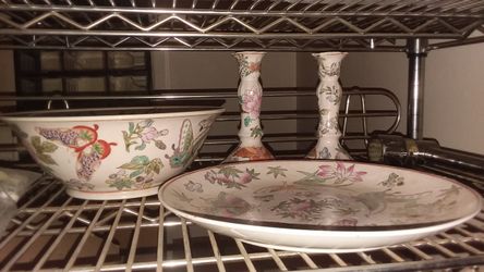 Four piece ceramic butterfly set. One candle holder has small chips as pictured.