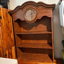 Composite wood shelves with clock that does not work anymore.