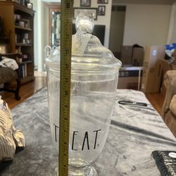 Rae Dunn clear glass apothecary jar with the word "TREAT" in black lettering