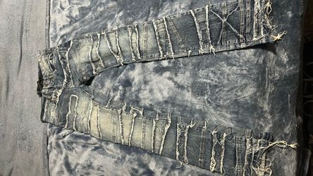 Stacked distressed denim jeans