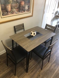 Like new gray dining table set with 4 black leather chairs