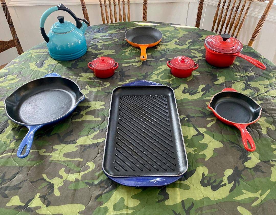 A Grouping Of Le Creuset Skillets Covered Pan And Tea Kettle