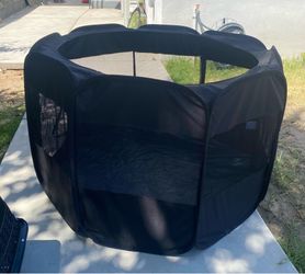 Portable black pet playpen..