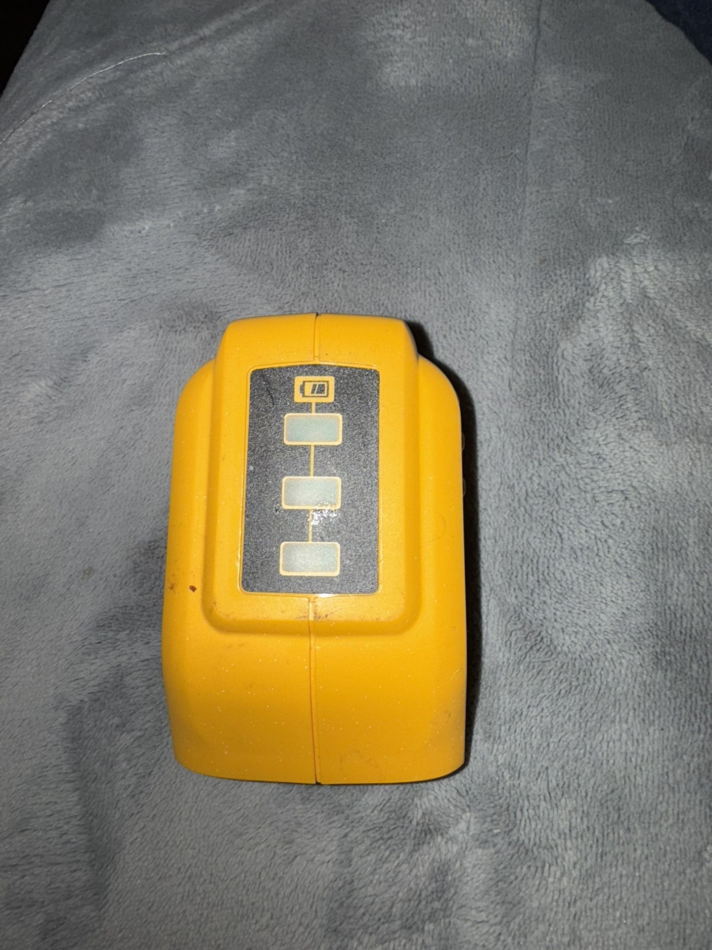 The Dewalt 12V/20V MAX USB Power Source DCB090 is a durable jobsite accessory with two small USB ports for charging electronic devices. It has a maxim